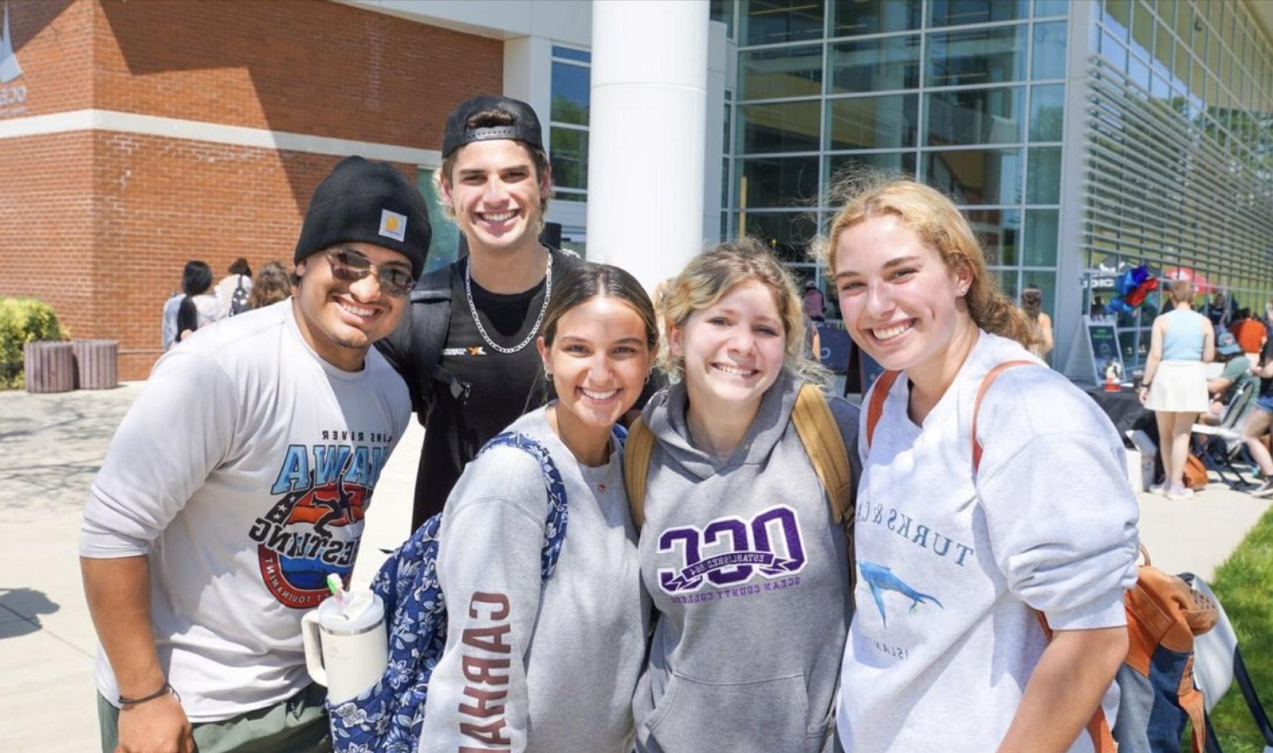 A group of smiling students on campus